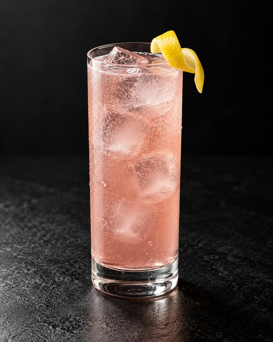 pale pink Bordelaise in a Collins glass over ice with lemon twist.