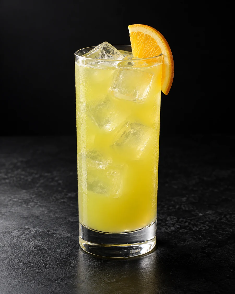 Yellow-green Melon Ball in a highball filled with ice, finished with an orange slice.